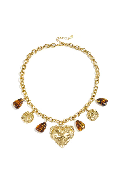 Gliederkette mit baumelnden Perlenmünzen und auffälligem Herz