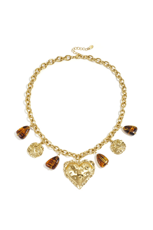 Gliederkette mit baumelnden Perlenmünzen und auffälligem Herz